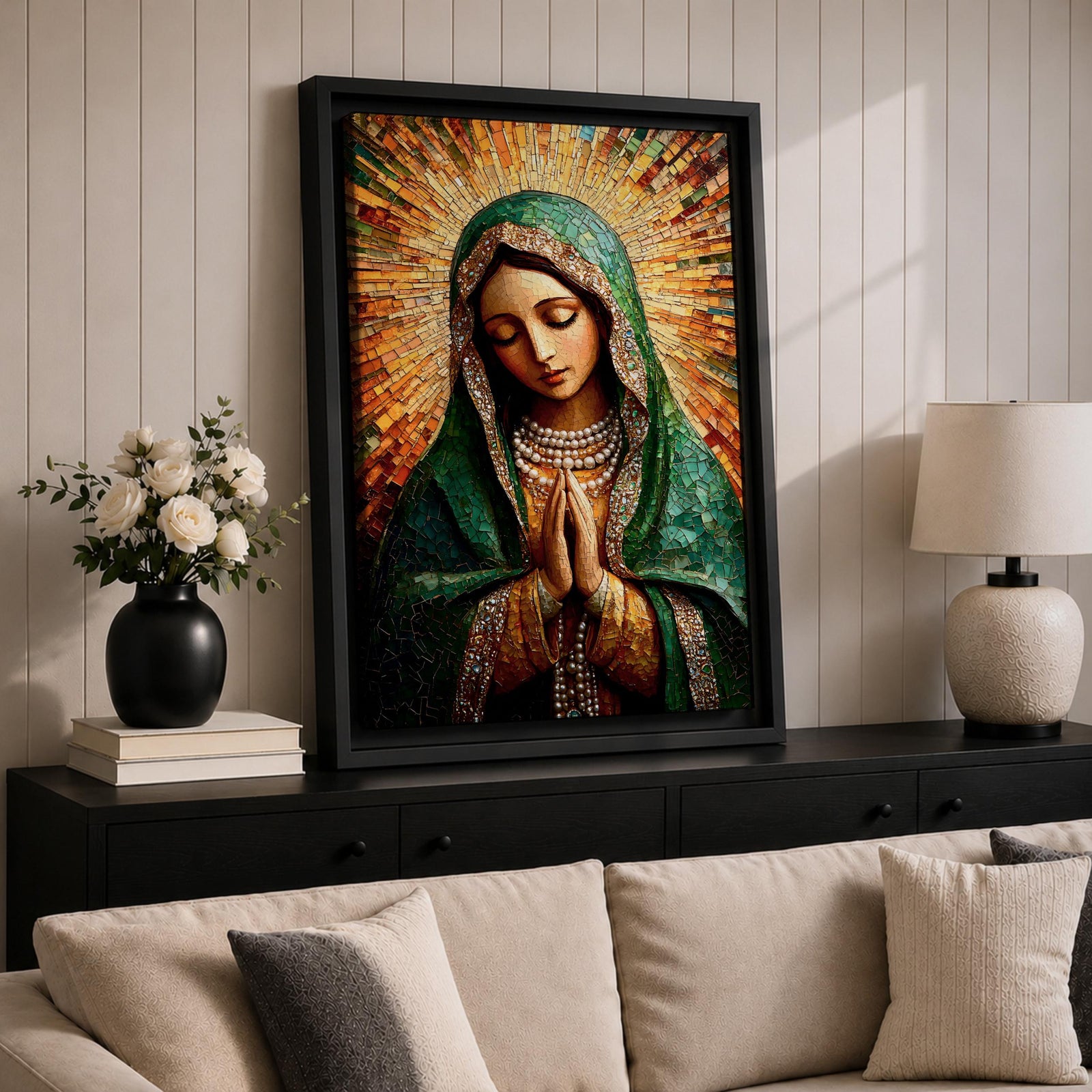 Mosaic style portrait of the Virgin Mary shown with head bowed and hands clasped in prayer, composed of small tile like fragments forming a devotional Catholic image. Radiant rays expand behind her while a detailed veil and necklace are rendered in textured mosaic pieces typical of religious icon artwork.