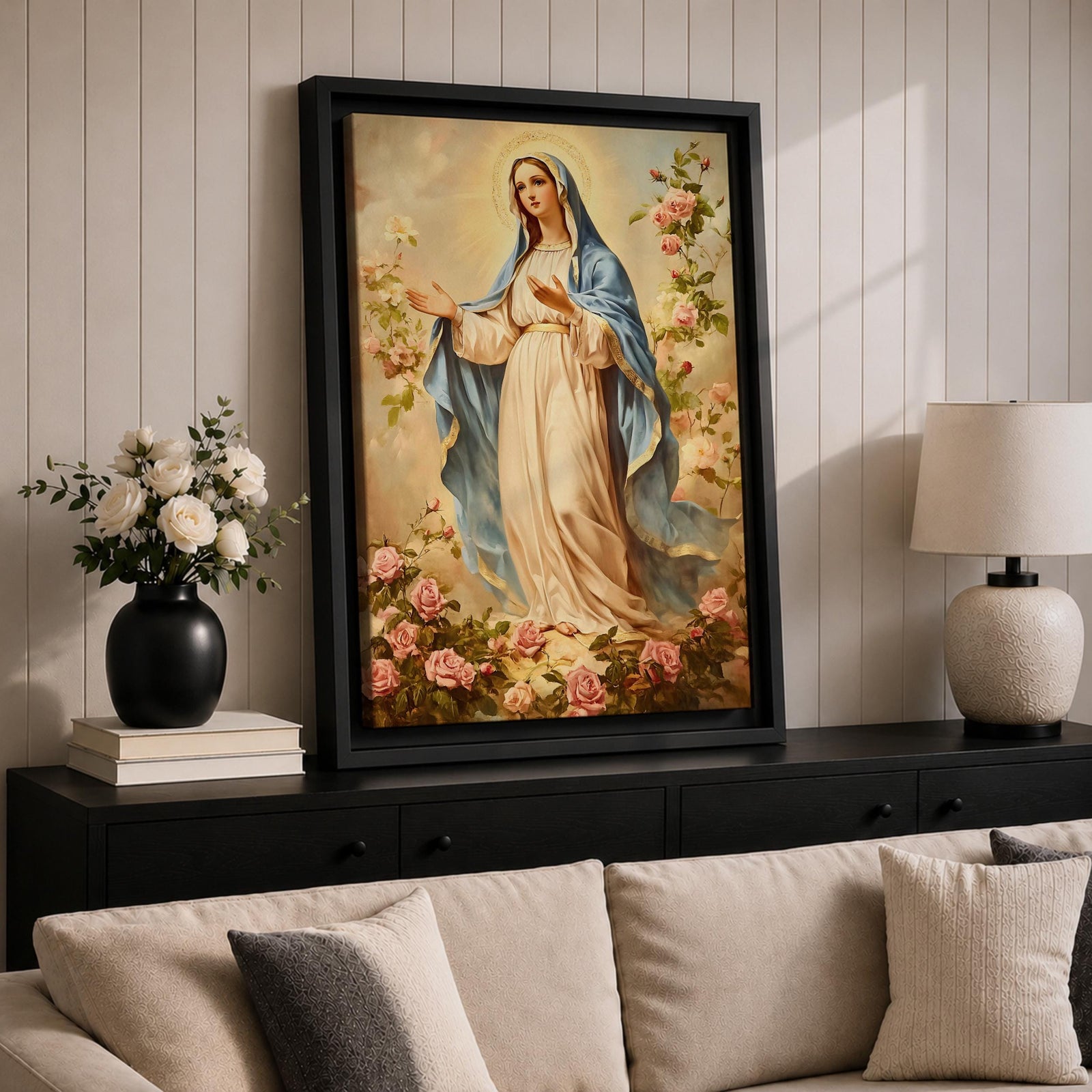 Vintage devotional painting of the Virgin Mary standing gracefully with open hands in a welcoming gesture, wearing a flowing cream robe and blue mantle while surrounded by blooming pink roses and a soft glowing halo above her head, rendered in a classical Madonna composition with delicate floral garden details.