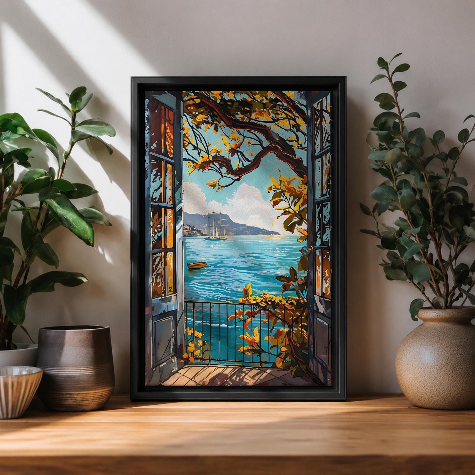 A framed canvas artwork depicting a Mediterranean balcony opening onto a vibrant coastal ocean view with sailboats on the water and leafy branches framing the scene. The style is realistic with bold, clear lines and vivid colors emphasizing the natural landscape and architectural elements.