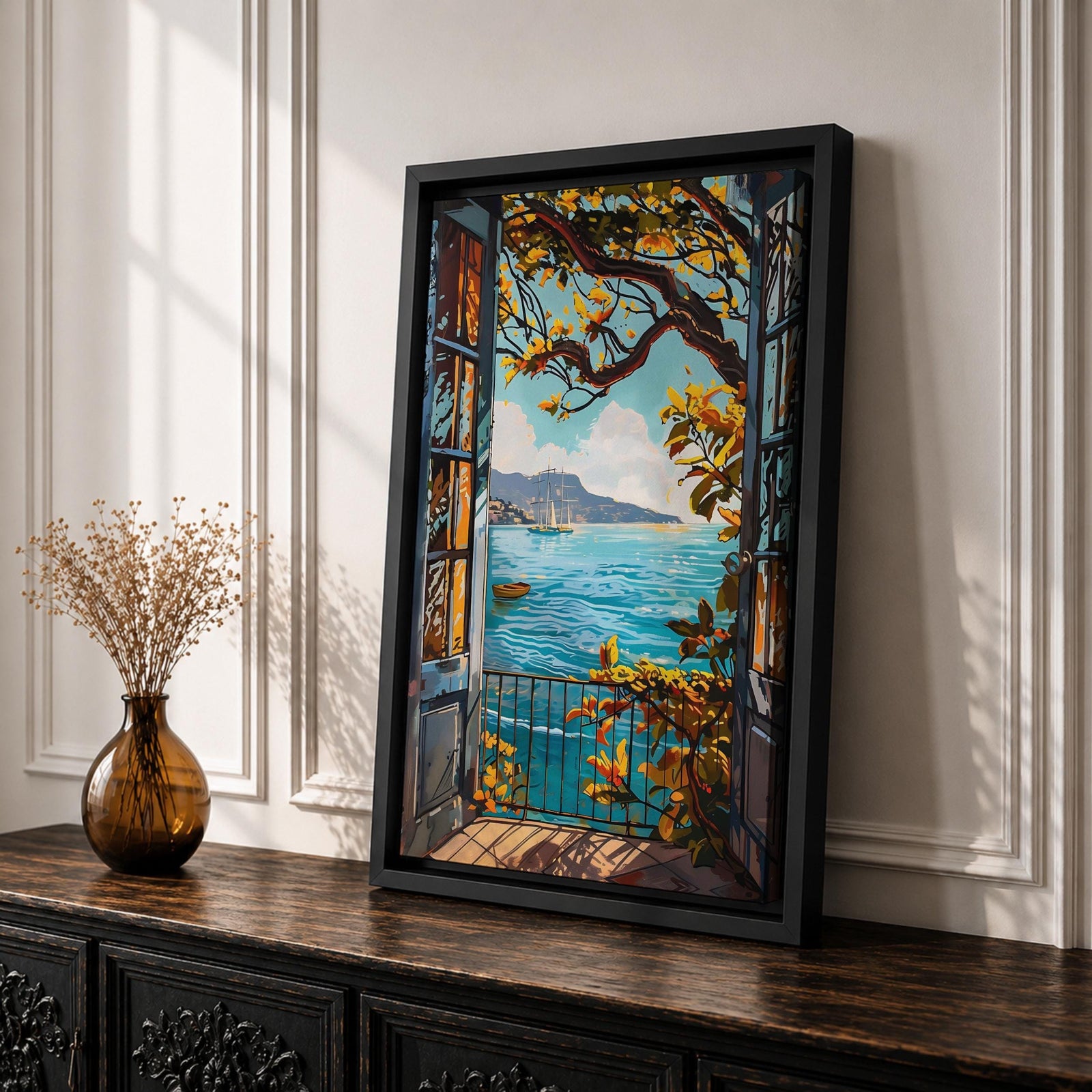 A framed canvas artwork depicting a Mediterranean balcony opening onto a vibrant coastal ocean view with sailboats on the water and leafy branches framing the scene. The style is realistic with bold, clear lines and vivid colors emphasizing the natural landscape and architectural elements.