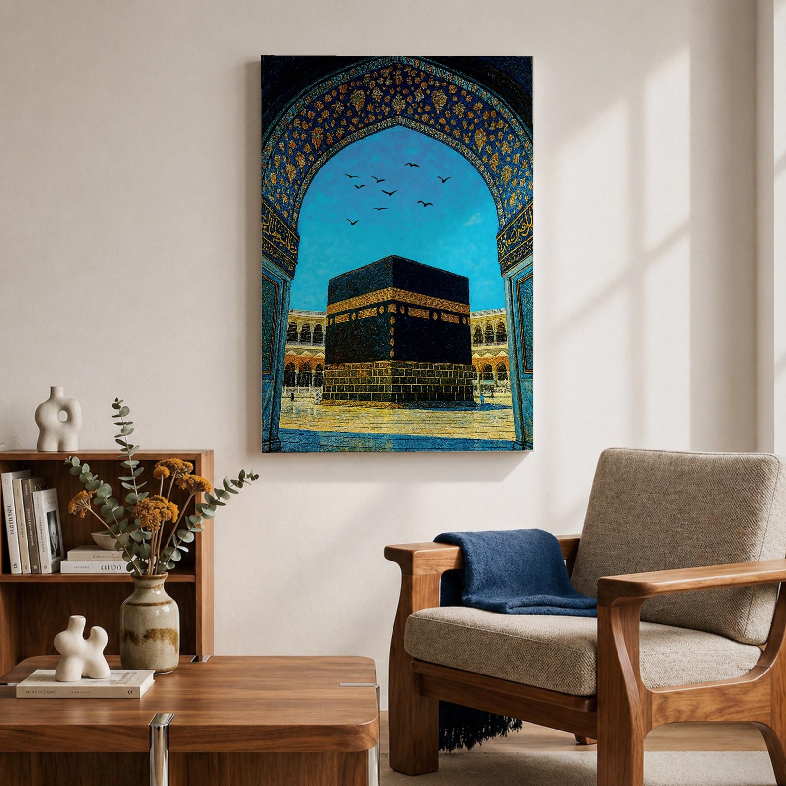 Artwork of the Kaaba in Masjid Haram framed by an ornate Moorish arabesque archway with intricate blue and gold patterns and birds flying across a bright sky above the mosque courtyard.