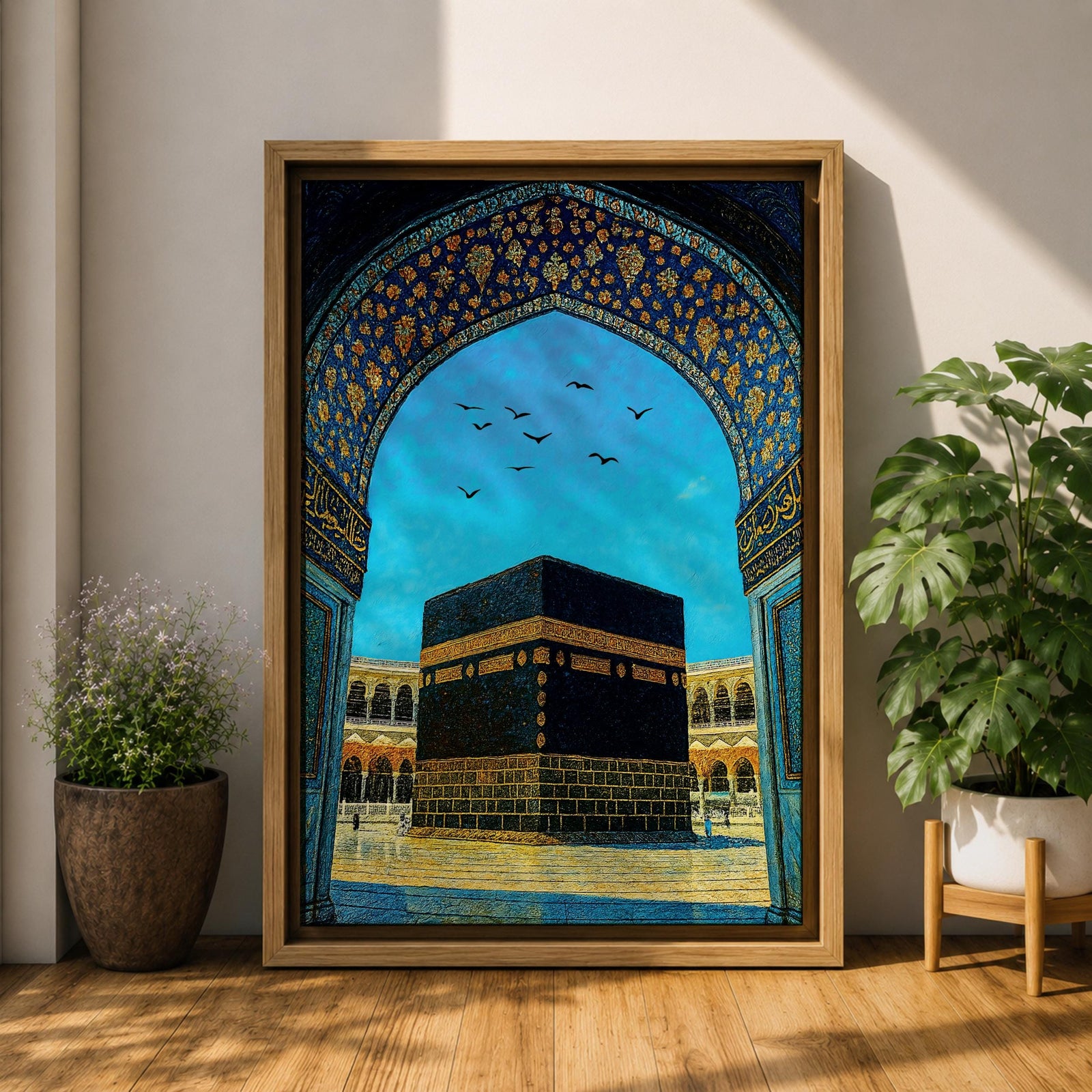 Artwork of the Kaaba in Masjid Haram framed by an ornate Moorish arabesque archway with intricate blue and gold patterns and birds flying across a bright sky above the mosque courtyard.
