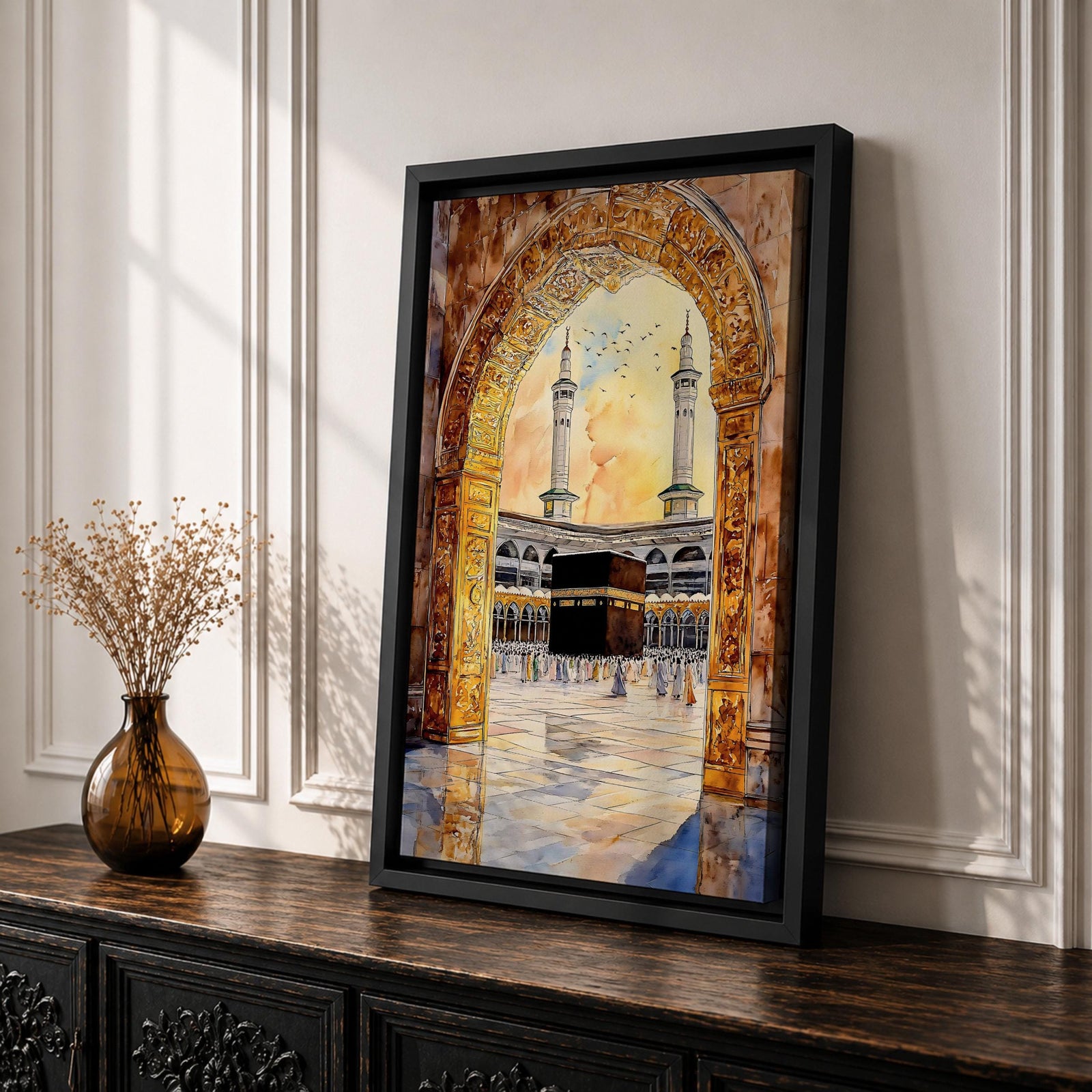 Watercolor artwork of the Kaaba in Masjid Haram viewed through an ornate mosque archway with twin minarets rising above the courtyard and pilgrims gathered around the sacred sanctuary.