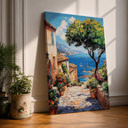 A vibrant framed canvas painting depicting a charming coastal village with stone-paved streets, terracotta rooftops, lush greenery, colorful flowers, and sailboats on a deep blue sea under a clear sky, rendered in a detailed, realistic style capturing Mediterranean summer ambiance.