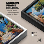 A vibrant framed canvas painting depicting a charming coastal village with stone-paved streets, terracotta rooftops, lush greenery, colorful flowers, and sailboats on a deep blue sea under a clear sky, rendered in a detailed, realistic style capturing Mediterranean summer ambiance.