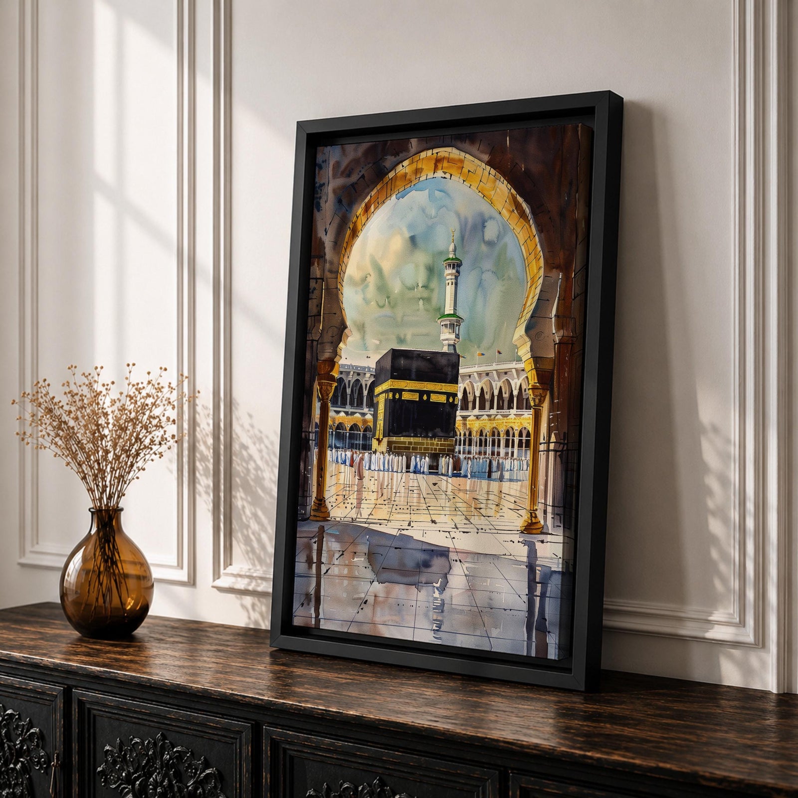 Watercolor-style painting of the Kaaba at Masjid Al Haram in Mecca viewed through a large mosque archway, with pilgrims standing in the courtyard and a tall minaret rising behind the sacred shrine.