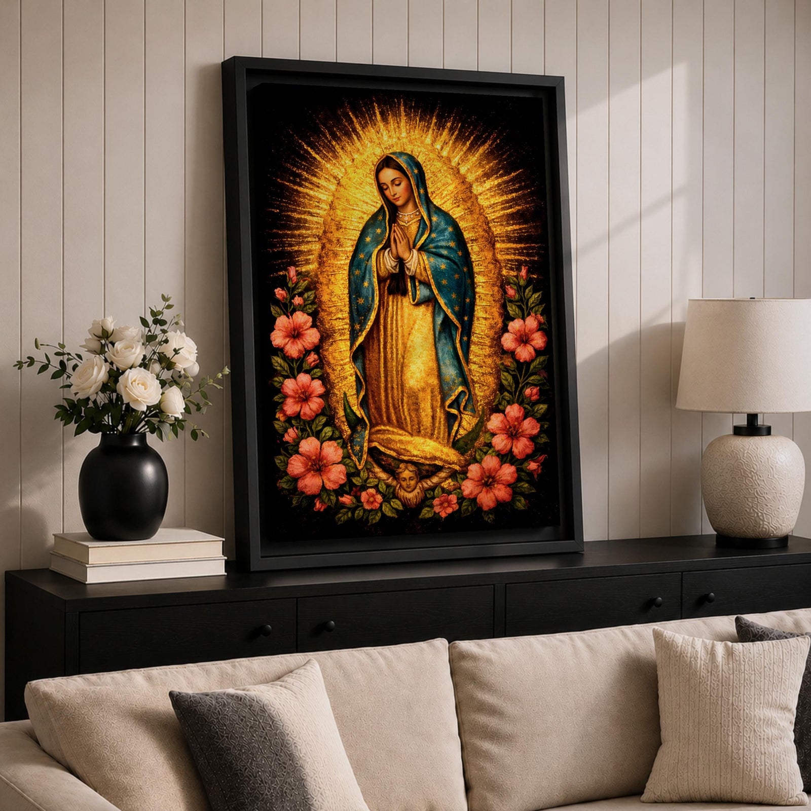 Devotional painting of Our Lady of Guadalupe standing in prayer with hands folded, wearing a blue mantle with stars and surrounded by radiant golden rays and vibrant hibiscus flowers in a colorful Mexican Catholic style.