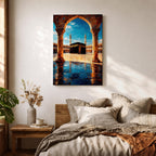 Framed wall art showing the Kaaba at Masjid Al Haram in Mecca viewed through a grand marble archway with columns and reflective courtyard tiles under a bright blue sky.