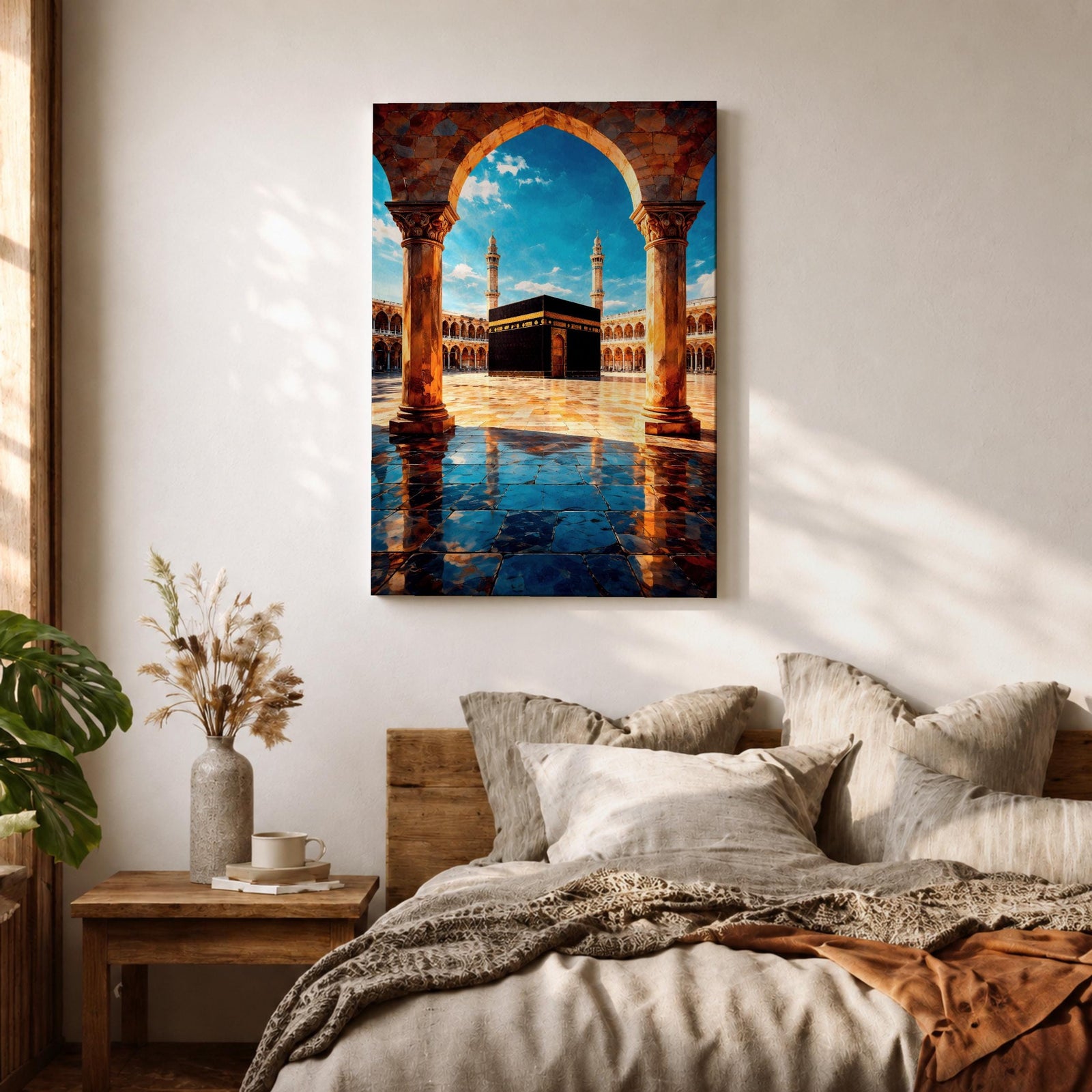 Framed wall art showing the Kaaba at Masjid Al Haram in Mecca viewed through a grand marble archway with columns and reflective courtyard tiles under a bright blue sky.