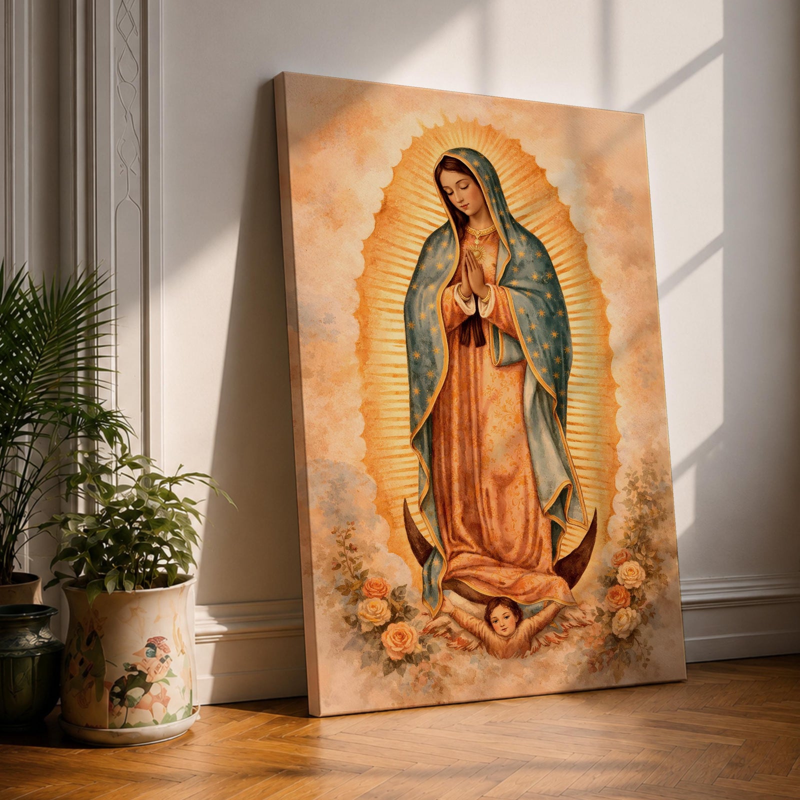 Painting of Our Lady of Guadalupe standing in a prayer pose with hands clasped and head bowed, wearing a flowing rose colored gown and a blue mantle decorated with stars, surrounded by radiant golden rays forming an oval halo, standing on a crescent moon supported by a small angel in traditional Catholic devotional style.