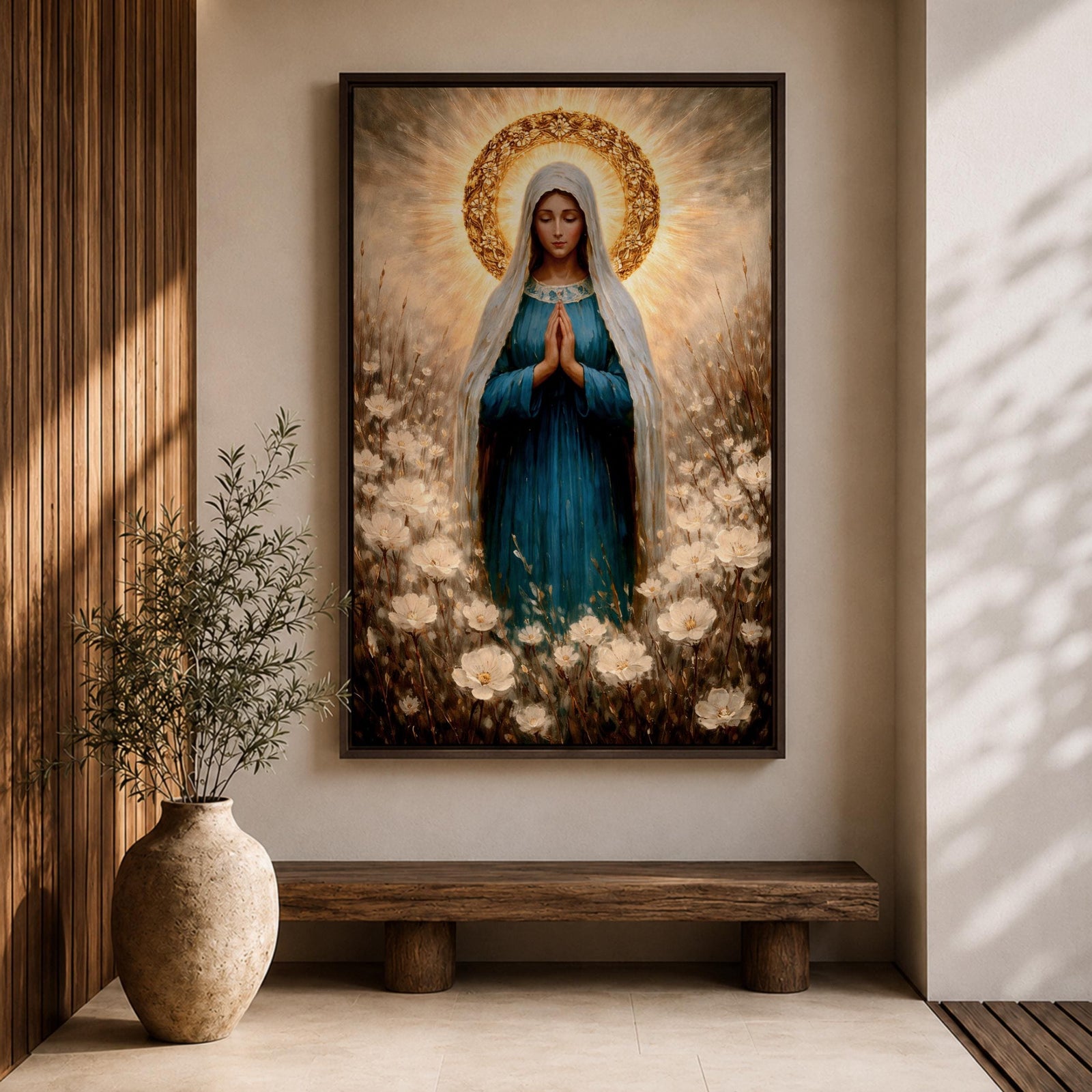 Painting of the Virgin Mary standing in prayer with hands clasped and head bowed, wearing a flowing blue robe and white veil, surrounded by a radiant golden halo and soft glowing light while standing within a field of delicate white wildflowers in a devotional Marian composition.