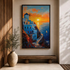 An impasto style framed canvas painting depicting a Santorini sunset over whitewashed buildings with a windmill on a cliffside overlooking the sea. The vibrant sunset sky reflects on the water with a small sailboat visible, capturing a Mediterranean coastal landscape scene with textured brushstrokes.