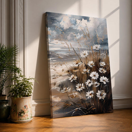 A vintage-style framed canvas wall art depicting a cluster of daisies and wild grasses by the beach. The artwork features textured brush strokes and muted coastal tones, blending floral elements with a rustic seaside atmosphere in a detailed floral composition.