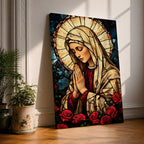 Stained glass style artwork of the Virgin Mary with head bowed and hands clasped in prayer, wearing a cream veil and red garment, surrounded by a radiant circular halo and red roses at the base, rendered with detailed stained glass panels and rich colors in a devotional Marian composition.