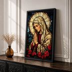 Stained glass style artwork of the Virgin Mary with head bowed and hands clasped in prayer, wearing a cream veil and red garment, surrounded by a radiant circular halo and red roses at the base, rendered with detailed stained glass panels and rich colors in a devotional Marian composition.