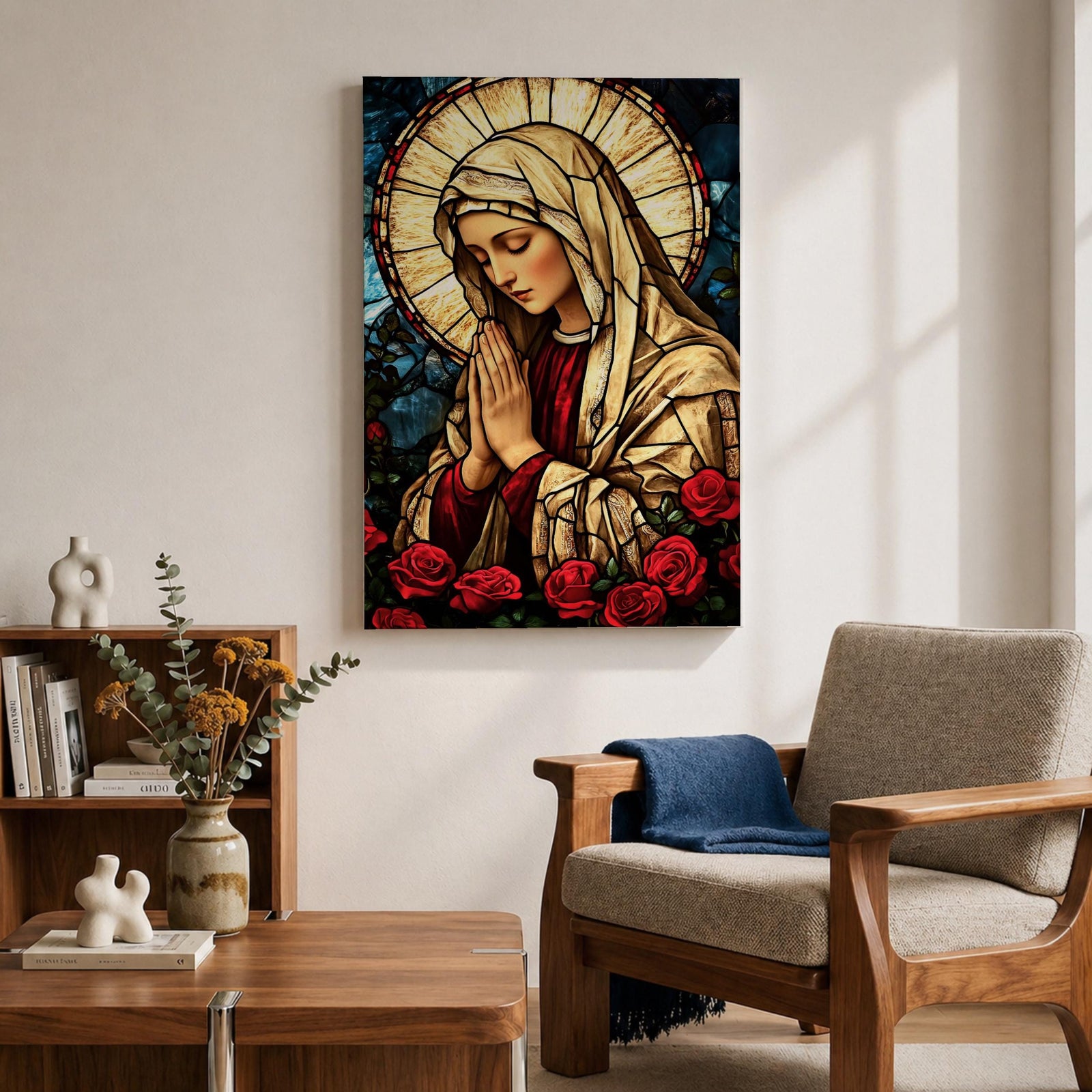 Stained glass style artwork of the Virgin Mary with head bowed and hands clasped in prayer, wearing a cream veil and red garment, surrounded by a radiant circular halo and red roses at the base, rendered with detailed stained glass panels and rich colors in a devotional Marian composition.
