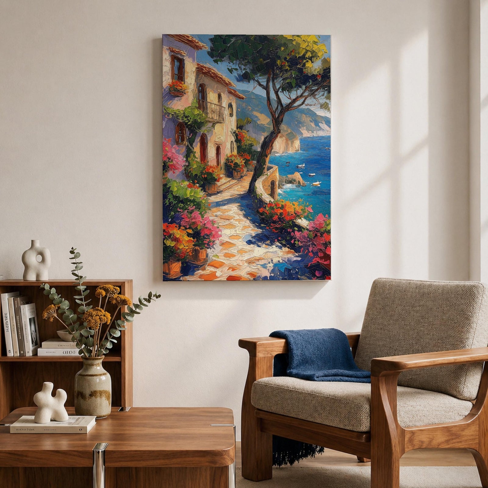 This artwork depicts a Mediterranean coastal scene featuring a charming seaside pathway lined with vibrant flowers and rustic buildings. The textured brushstrokes create a lively impressionistic landscape with a tree in the foreground and boats floating on the blue sea, capturing the essence of coastal tranquility.