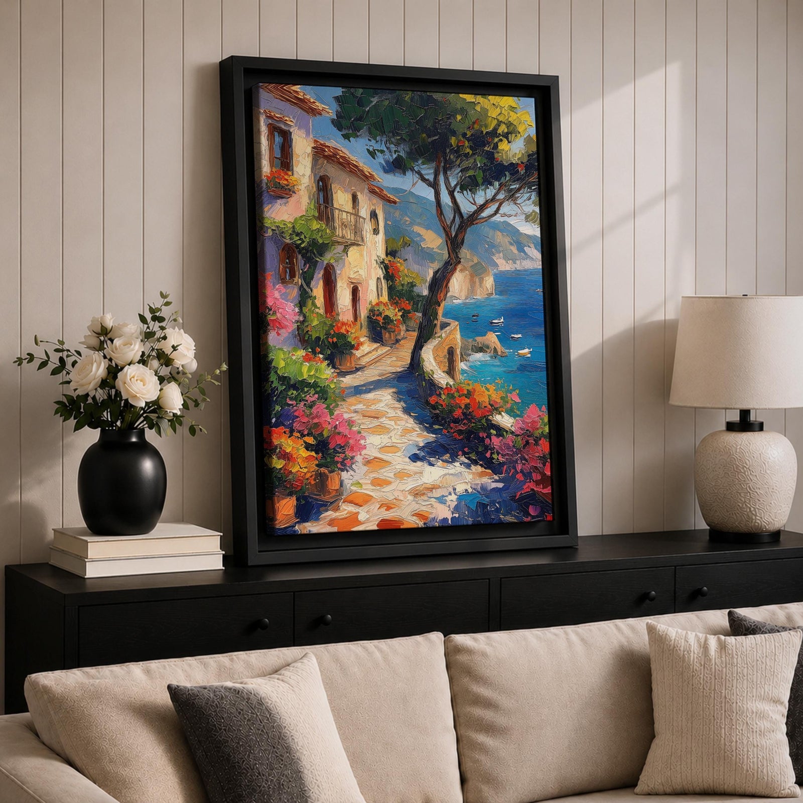 This artwork depicts a Mediterranean coastal scene featuring a charming seaside pathway lined with vibrant flowers and rustic buildings. The textured brushstrokes create a lively impressionistic landscape with a tree in the foreground and boats floating on the blue sea, capturing the essence of coastal tranquility.