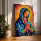 Colorful devotional painting of Our Lady of Guadalupe shown with hands clasped in prayer, wearing a blue star covered mantle over a rose dress while radiant golden rays form a glowing halo behind her figure. The composition presents the Virgin Mary in a vibrant painterly style with bold brushstrokes and centered sacred portrait.