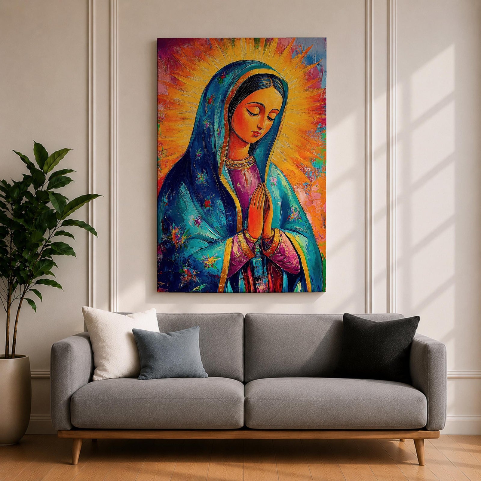 Colorful devotional painting of Our Lady of Guadalupe shown with hands clasped in prayer, wearing a blue star covered mantle over a rose dress while radiant golden rays form a glowing halo behind her figure. The composition presents the Virgin Mary in a vibrant painterly style with bold brushstrokes and centered sacred portrait.