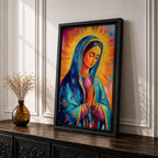 Colorful devotional painting of Our Lady of Guadalupe shown with hands clasped in prayer, wearing a blue star covered mantle over a rose dress while radiant golden rays form a glowing halo behind her figure. The composition presents the Virgin Mary in a vibrant painterly style with bold brushstrokes and centered sacred portrait.