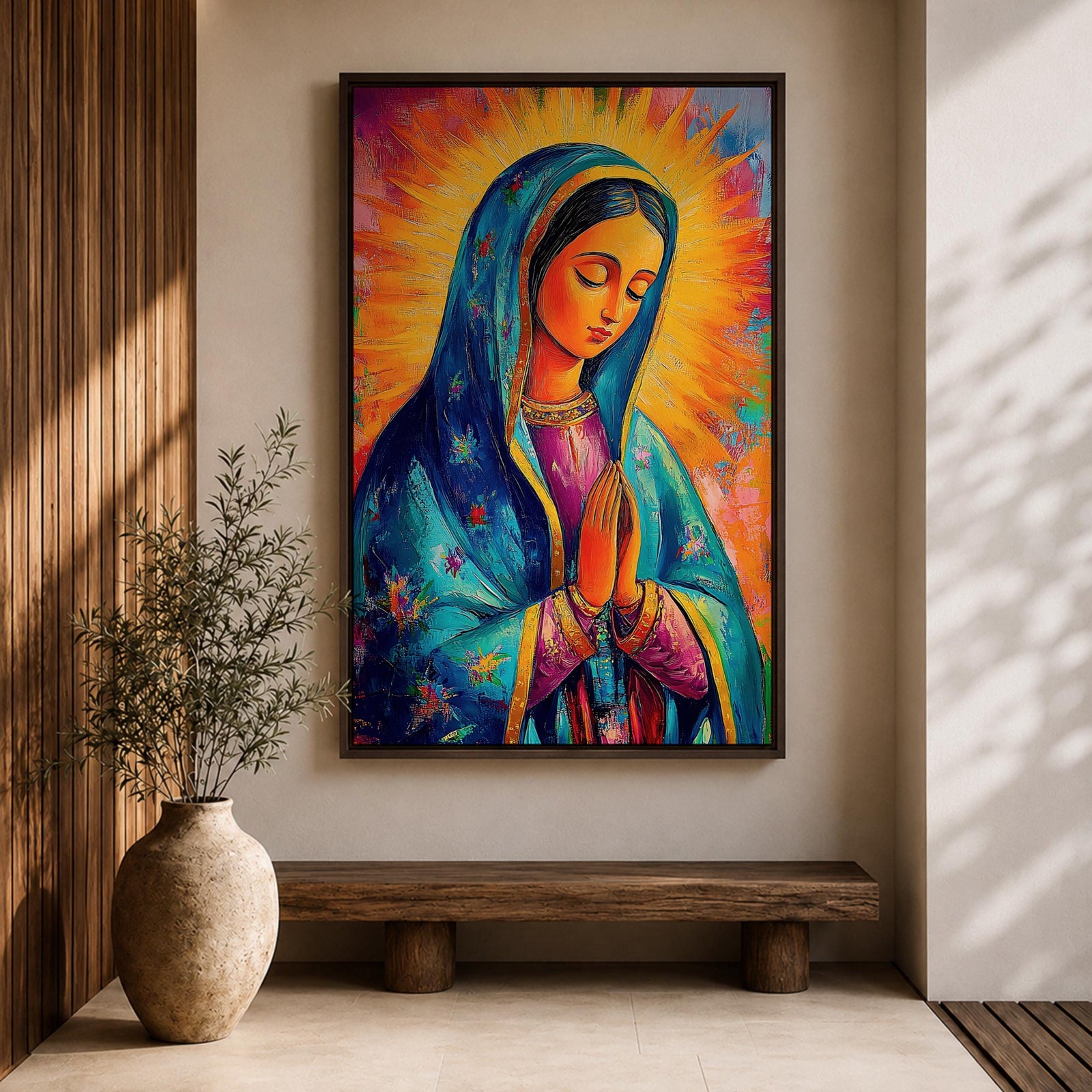 Colorful devotional painting of Our Lady of Guadalupe shown with hands clasped in prayer, wearing a blue star covered mantle over a rose dress while radiant golden rays form a glowing halo behind her figure. The composition presents the Virgin Mary in a vibrant painterly style with bold brushstrokes and centered sacred portrait.