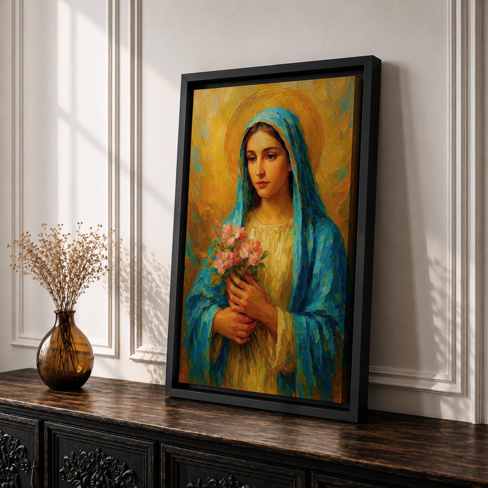 This impasto style painting depicts the Virgin Mary, also known as the Blessed Mother, holding pink flowers with a golden halo background. The textured brushstrokes and vibrant colors emphasize her serene expression and traditional blue veil, creating a devotional religious portrait.