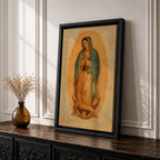 A framed vintage-style depiction of Our Lady of Guadalupe shows a praying woman draped in a starry mantle with a glowing aura, standing on a crescent moon supported by an angel's face, rendered in warm tones with a textured aged background.