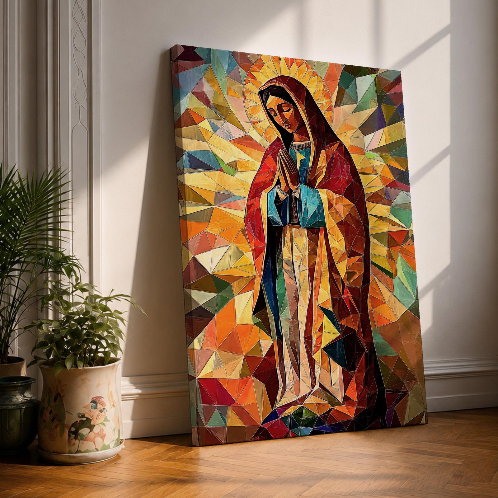 Geometric mosaic style depiction of Our Lady of Guadalupe shown standing in prayer with hands joined, surrounded by radiant golden halo rays and colorful angular shapes forming a stained glass inspired composition that highlights the Virgin Mary in a modern geometric Catholic devotional design.