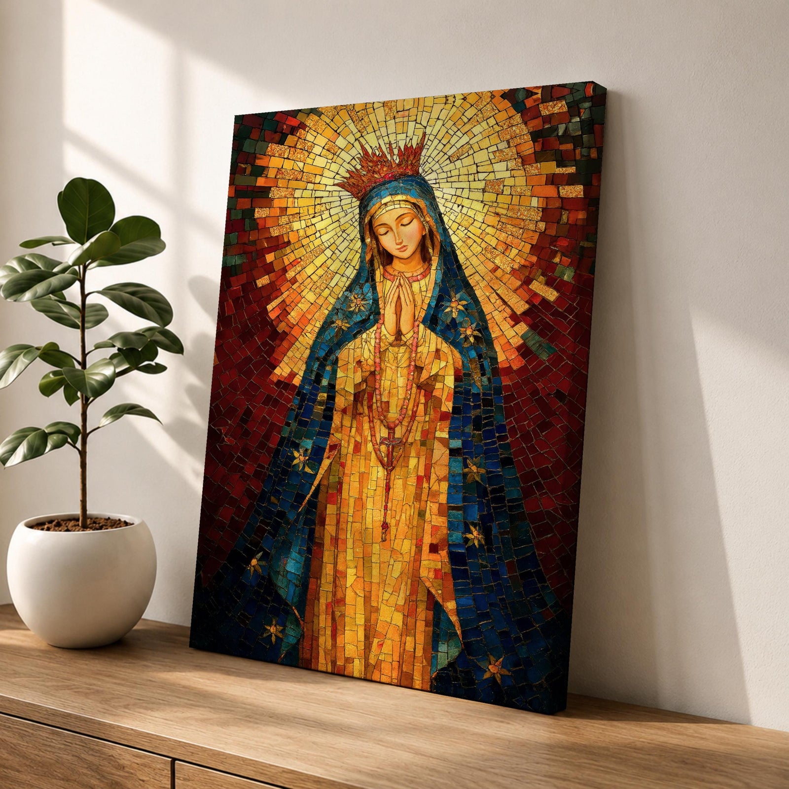 A mosaic-style icon of Virgin Mary depicts the Blessed Mother with hands clasped in prayer, wearing a blue mantle adorned with stars and a radiant golden halo behind her head, composed of small colorful tiles forming a vibrant religious portrait.