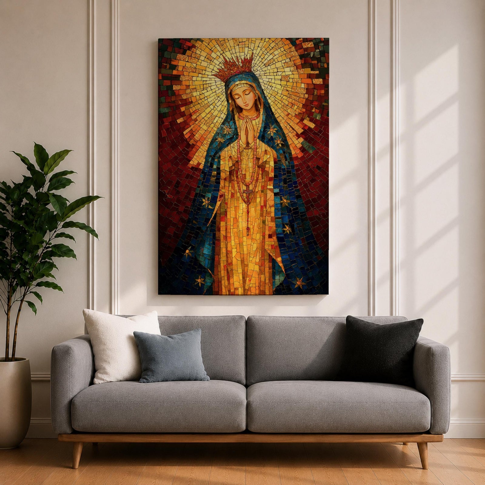 A mosaic-style icon of Virgin Mary depicts the Blessed Mother with hands clasped in prayer, wearing a blue mantle adorned with stars and a radiant golden halo behind her head, composed of small colorful tiles forming a vibrant religious portrait.