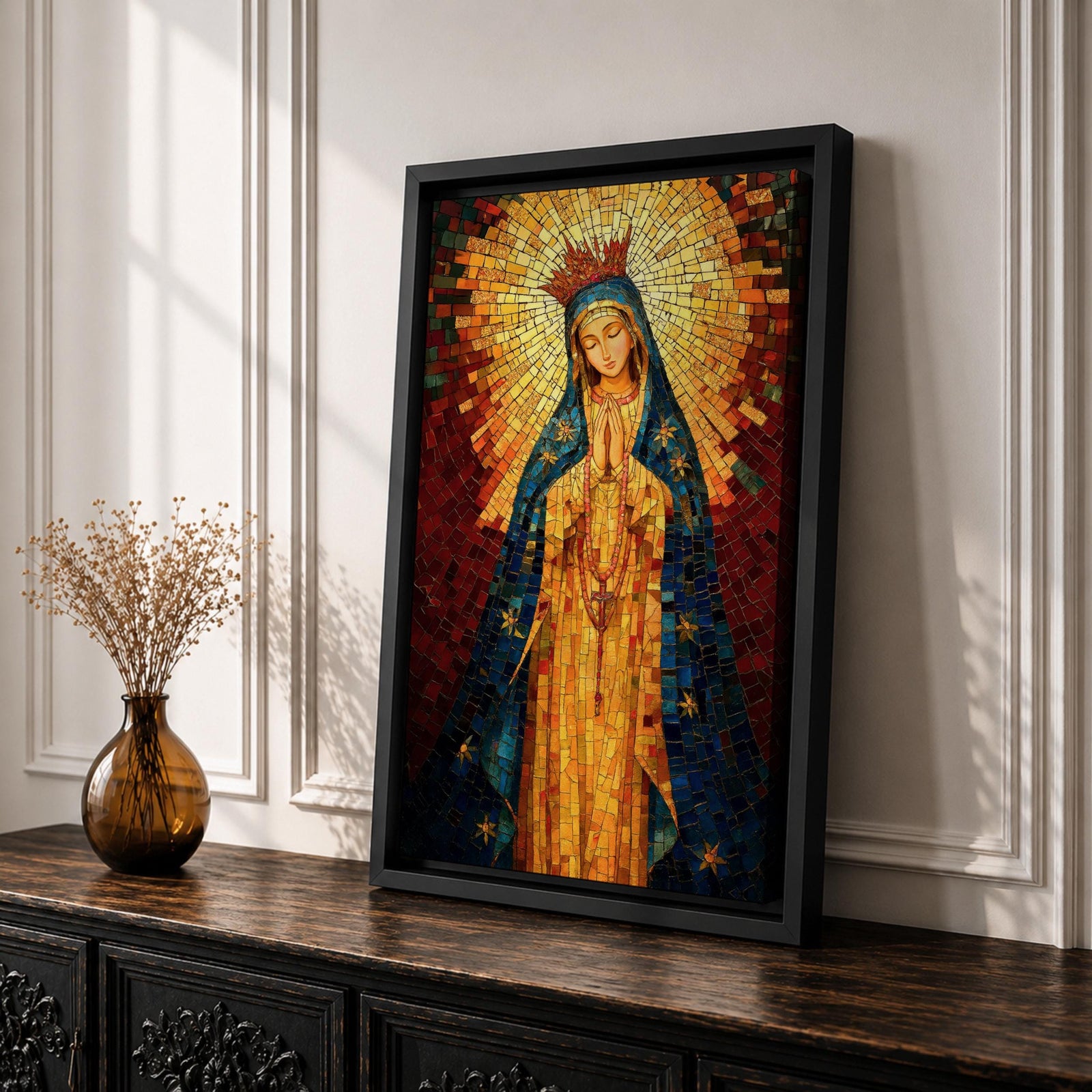 A mosaic-style icon of Virgin Mary depicts the Blessed Mother with hands clasped in prayer, wearing a blue mantle adorned with stars and a radiant golden halo behind her head, composed of small colorful tiles forming a vibrant religious portrait.
