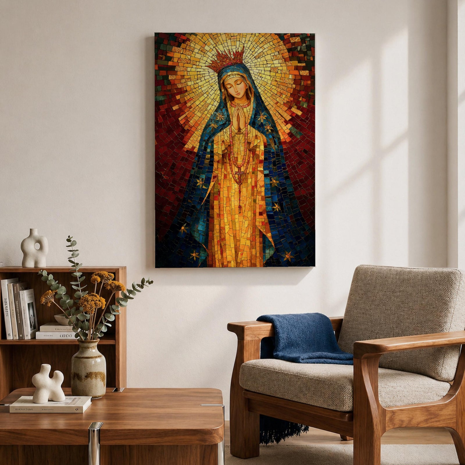 A mosaic-style icon of Virgin Mary depicts the Blessed Mother with hands clasped in prayer, wearing a blue mantle adorned with stars and a radiant golden halo behind her head, composed of small colorful tiles forming a vibrant religious portrait.