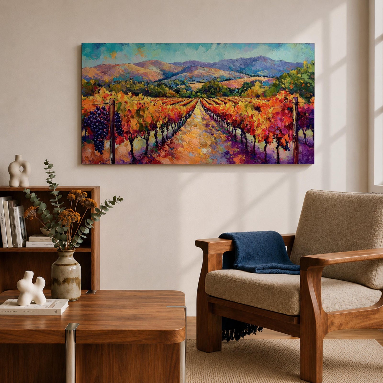A panoramic vineyard landscape painting showing long rows of grapevines covered in red and golden autumn leaves stretching toward distant mountains beneath a bright sky. Purple grape clusters hang beside the vines while a central path leads through the field, capturing a colorful wine country valley with bold impressionist brushstrokes.