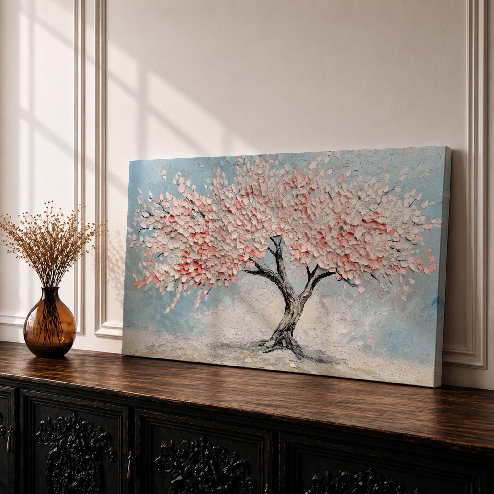 Panoramic textured painting of a cherry blossom tree with a twisting dark trunk and a wide canopy of soft pink blossoms spreading across a pale blue sky. Thick palette knife strokes create layered petals and raised textures, forming a calm spring landscape with delicate floral clusters and gentle pastel tones.