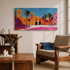 Panoramic painting of a Moroccan kasbah with tall palm trees and arched fortress gates rendered in bold palette knife brushstrokes. Bright orange, pink, and terracotta buildings contrast against a vivid blue sky, capturing the architecture of a Marrakech medina with textured walls and sunlit desert tones.