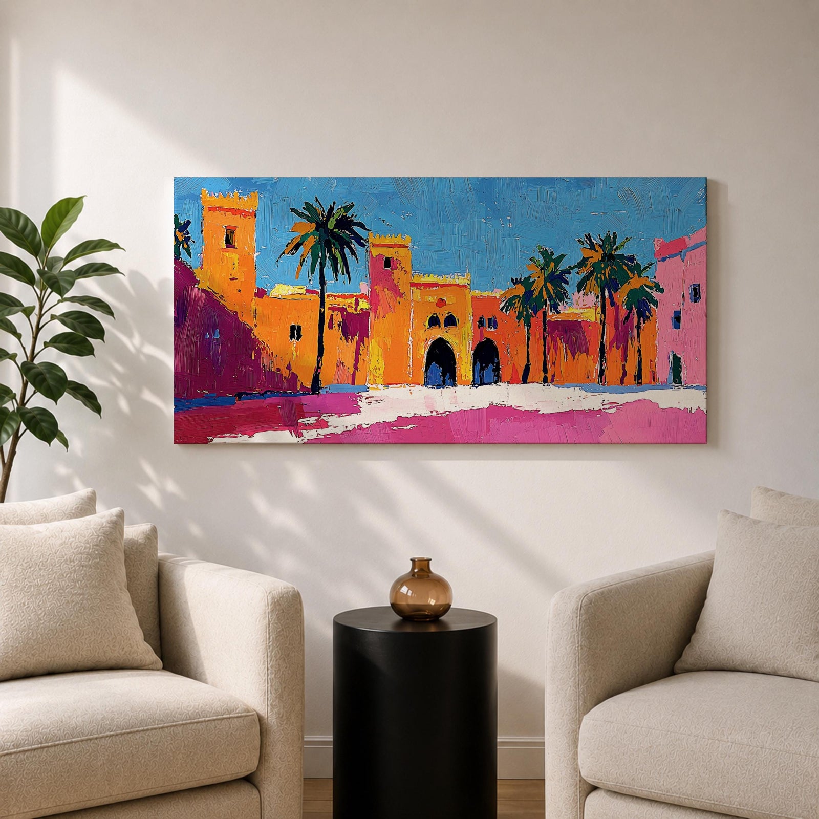 Panoramic painting of a Moroccan kasbah with tall palm trees and arched fortress gates rendered in bold palette knife brushstrokes. Bright orange, pink, and terracotta buildings contrast against a vivid blue sky, capturing the architecture of a Marrakech medina with textured walls and sunlit desert tones.