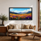 Panoramic painting of a vibrant mountain meadow filled with colorful wildflowers stretching toward distant alpine peaks. Red, yellow, purple, and blue blossoms cover the valley floor beneath a bright sky with soft clouds, while layered mountains rise along the horizon in a luminous natural landscape.