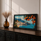 Panoramic painting of the Amalfi Coast with white seaside buildings and a domed church overlooking bright turquoise Mediterranean waters. Lemon branches heavy with citrus fruit frame the scene while mountains rise behind the coastal village beneath a blue sky with scattered clouds.