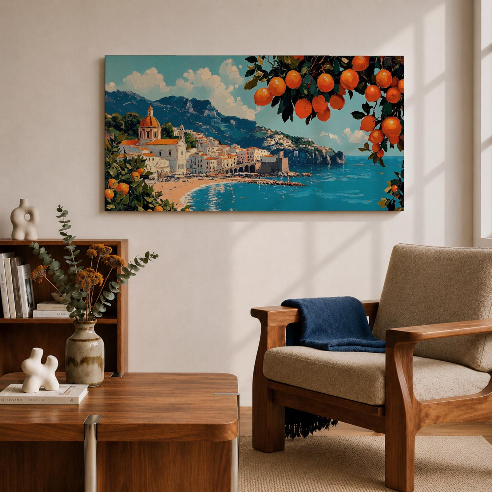 Panoramic painting of the Amalfi Coast with white seaside buildings and a domed church overlooking bright turquoise Mediterranean waters. Lemon branches heavy with citrus fruit frame the scene while mountains rise behind the coastal village beneath a blue sky with scattered clouds.