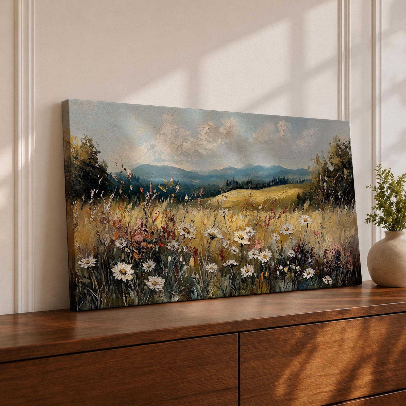 Panoramic painting of a peaceful wildflower meadow filled with blooming daisies and tall grasses across rolling countryside fields. Soft clouds stretch above distant hills while warm golden tones and textured brushstrokes create a calm rural landscape scene.