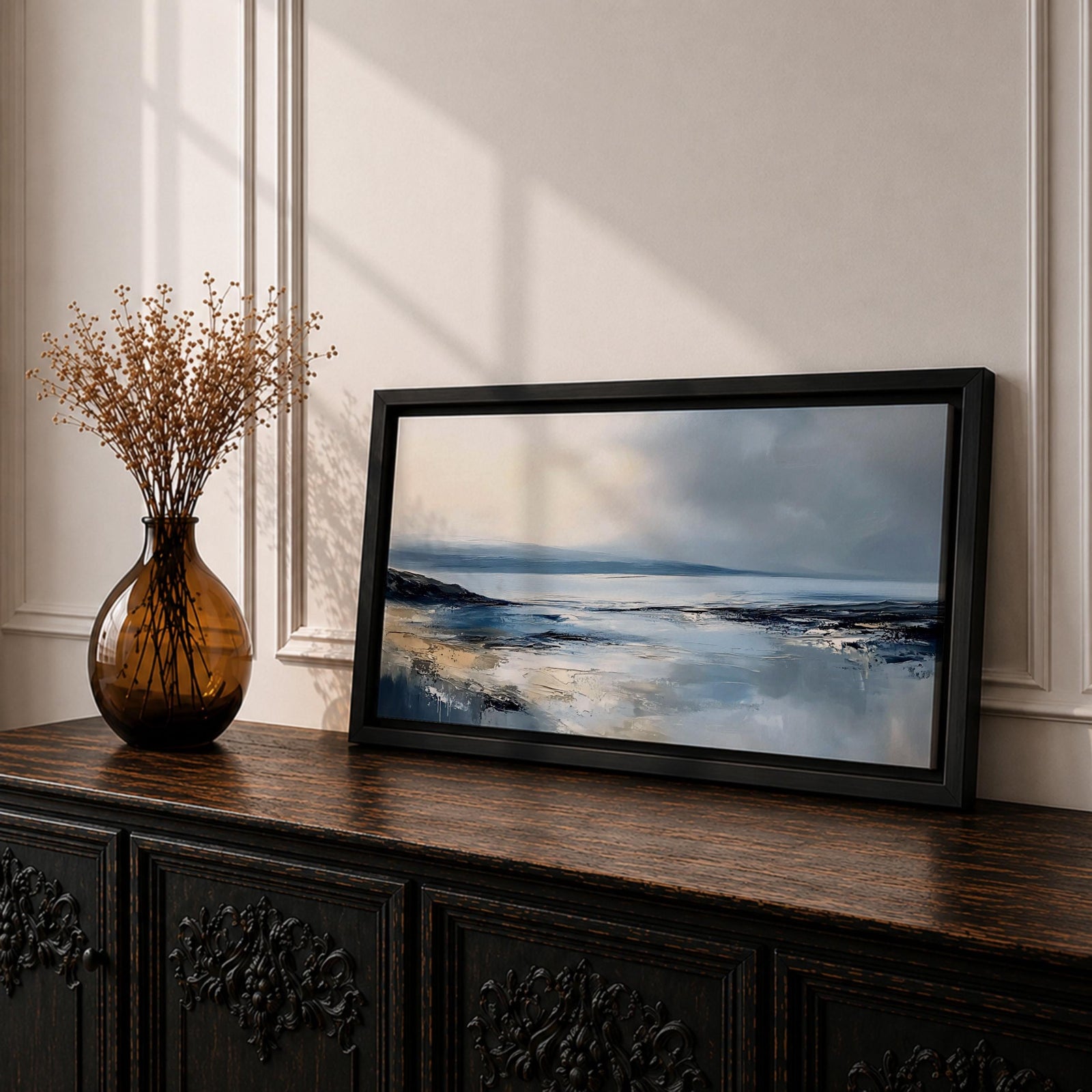 Panoramic abstract coastal seascape painting featuring a calm ocean shoreline with soft blue, gray, and sandy tones reflecting across the water beneath a cloudy horizon.