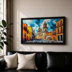 Panoramic painting of Oaxaca cathedral rising above a colorful colonial street lined with bright orange and yellow buildings. The historic Mexican architecture features twin cathedral towers beneath a dramatic blue sky with expressive painterly brushstrokes.