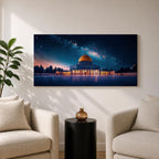 Panoramic night scene of the Dome of the Rock mosque in Jerusalem illuminated beneath a star filled sky and Milky Way galaxy. The golden dome reflects soft light across the courtyard while the historic Islamic architecture stands against the deep blue night horizon.