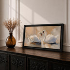 Panoramic painting depicting two white swans facing each other on calm water with their curved necks forming a heart shape. Soft brushstrokes and warm neutral tones surround the birds while gentle reflections appear on the lake surface, creating a serene composition centered on the pair of swans.