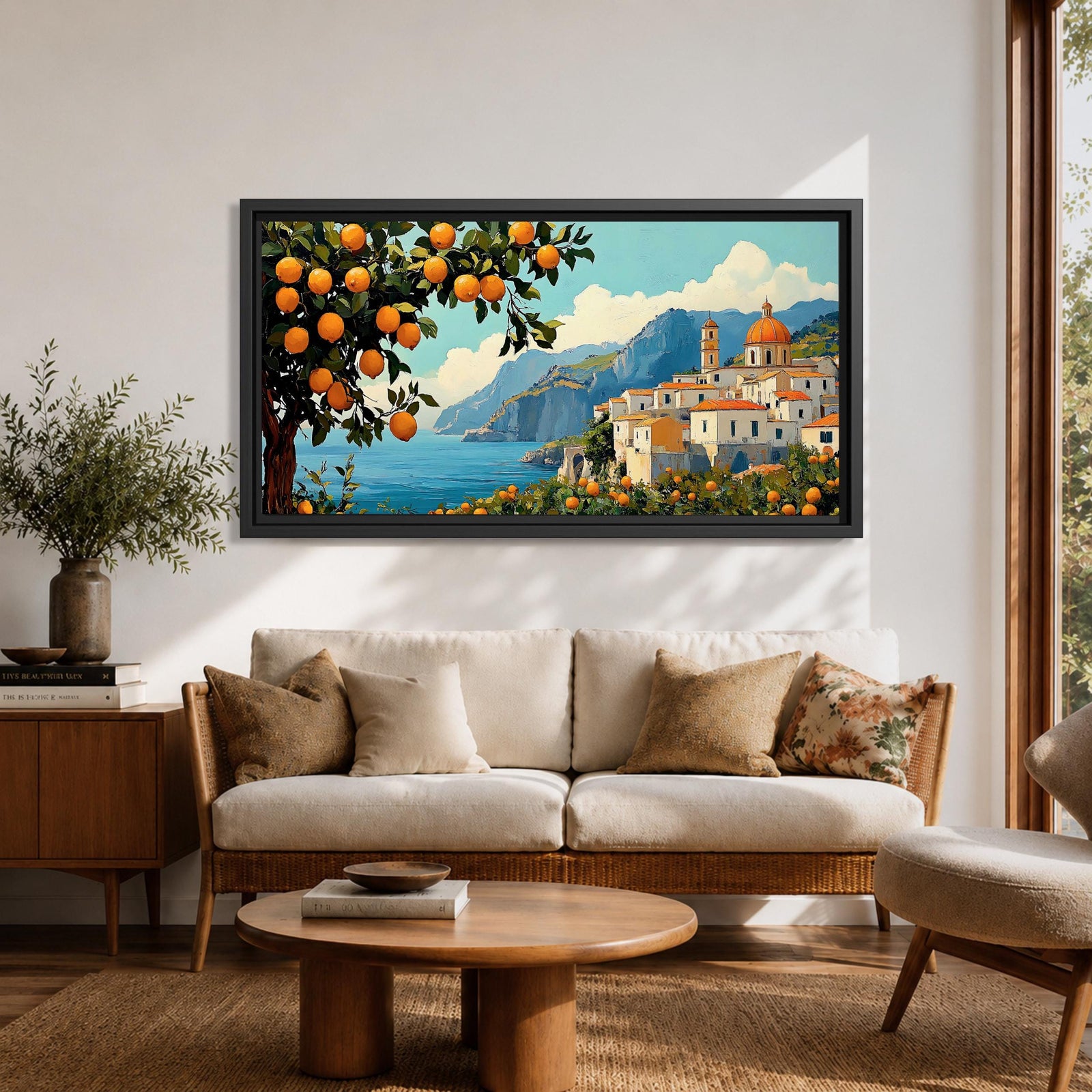 Panoramic coastal artwork showing a Mediterranean village overlooking the sea with white buildings and a domed church set against blue mountains. In the foreground a large lemon tree heavy with bright citrus fruit frames the scene while additional lemons and greenery fill the lower landscape, creating a vibrant Amalfi Coast inspired composition.