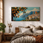 Panoramic coastal artwork showing a Mediterranean village overlooking the sea with white buildings and a domed church set against blue mountains. In the foreground a large lemon tree heavy with bright citrus fruit frames the scene while additional lemons and greenery fill the lower landscape, creating a vibrant Amalfi Coast inspired composition.