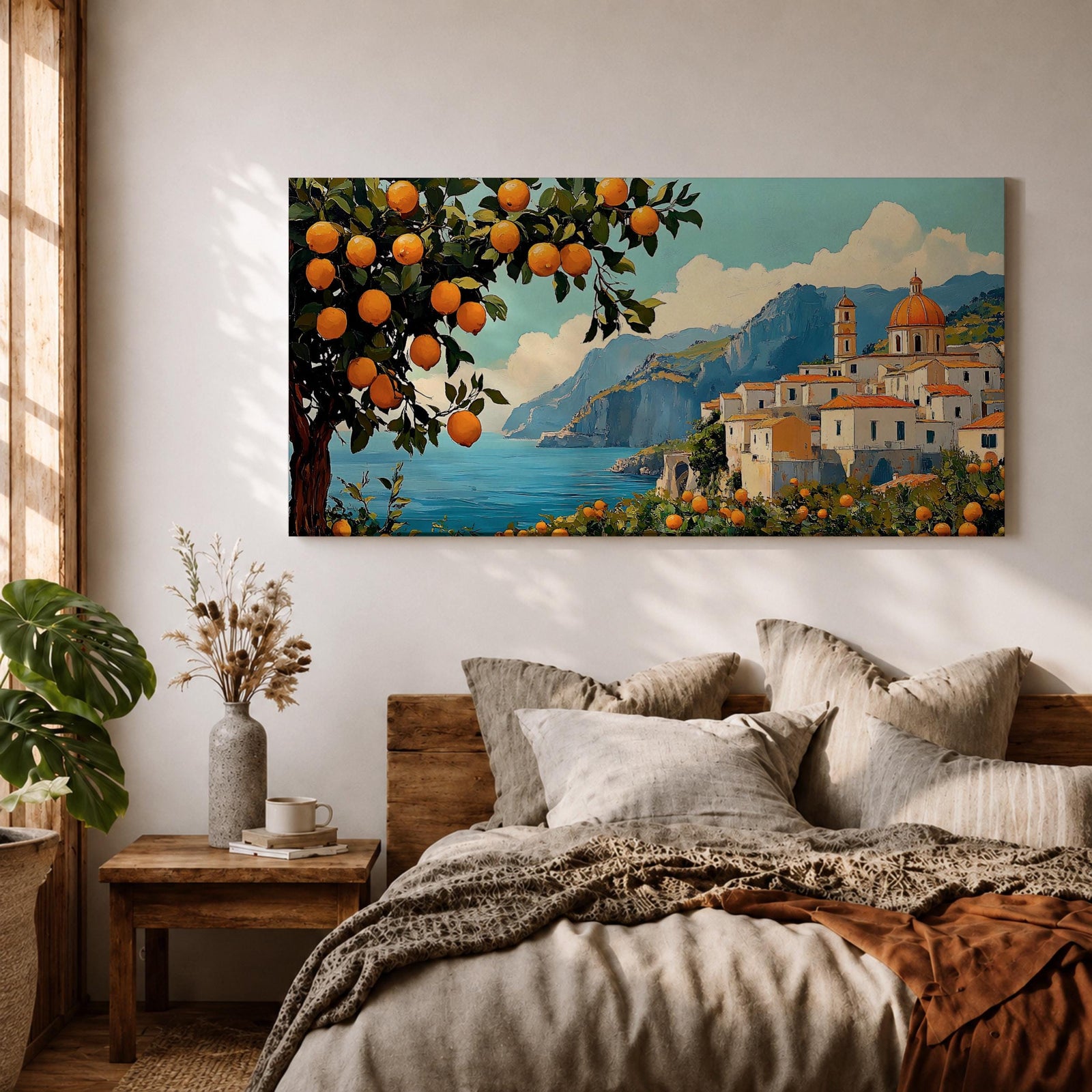 Panoramic coastal artwork showing a Mediterranean village overlooking the sea with white buildings and a domed church set against blue mountains. In the foreground a large lemon tree heavy with bright citrus fruit frames the scene while additional lemons and greenery fill the lower landscape, creating a vibrant Amalfi Coast inspired composition.
