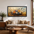 Panoramic painting depicting a vibrant cluster of wildflowers growing through tall meadow grasses. Bright blossoms in orange, blue, purple, and white rise from textured golden stems while loose expressive brushstrokes create movement across the floral arrangement and surrounding field.