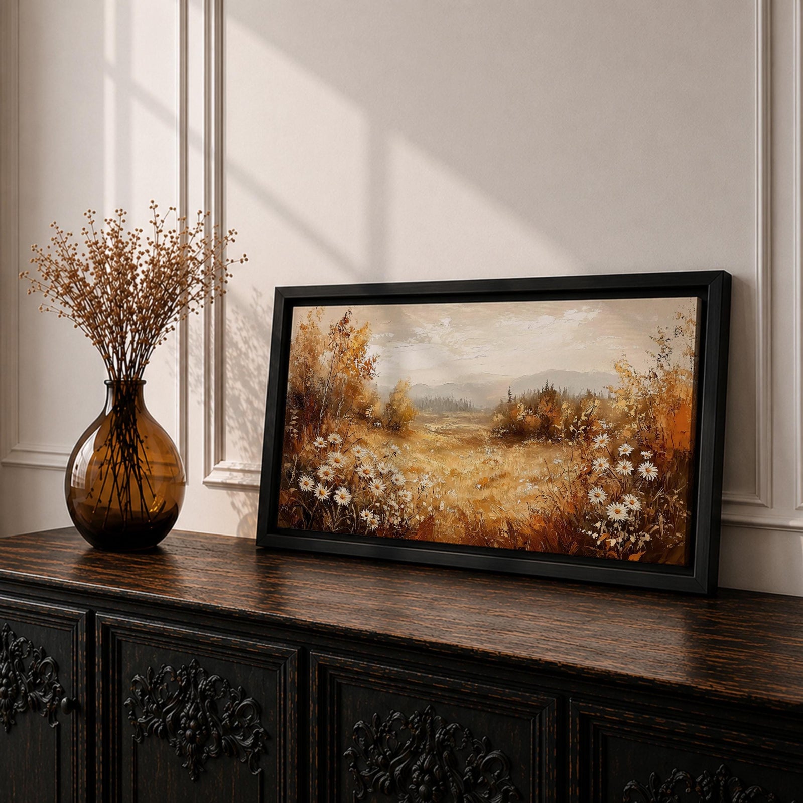Panoramic landscape painting depicting a golden autumn meadow with white daisies blooming along the foreground. Warm earthy tones fill the grassy field while trees with autumn foliage frame the scene and distant hills fade softly beneath a calm sky.